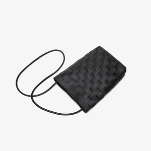 Minimalist black woven leather bucket bag with Intrecciato pattern and thin strap