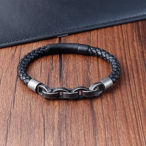 Close-up of black braided leather bracelet with metal links and matte magnetic clasp