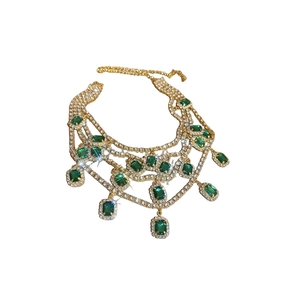 Luxurious tiered gold necklace with emerald-green rectangular stones and crystal accents