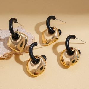 Minimalist geometric gold metal earrings featuring circular and square textured stone accents