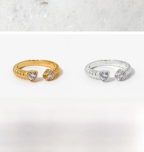 Detail view of gold and silver stainless steel rings with screw texture and zircons
