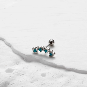Macro shot of silver stainless steel stud with blue stone and screw-back ball detail
