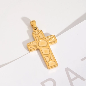Vue détaillée d'un pendentif croix en acier inoxydable doré aux textures géométriques
