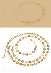 Detail of 18K gold plated stainless steel daisy necklace and bracelet with enamel charms