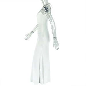 Detail of elegant white ruched long dress featuring a slim fit and textured fabric