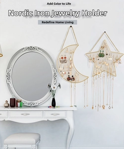 Close-up of gold iron mesh wall organizer in star and moon shapes for hanging jewelry