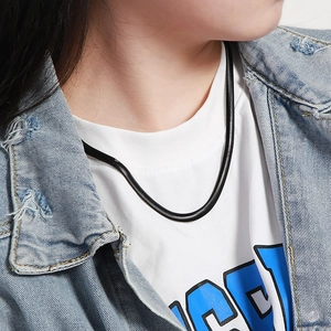 Close-up of black titanium snake bone chain worn by a model over a white t-shirt