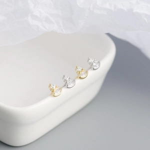 Macro view of gold and silver S925 sterling silver marquise stud earrings with cubic zirconia