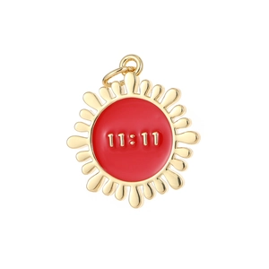 Golden sunburst pendant with 11:11 engraving and red enamel center on white background
