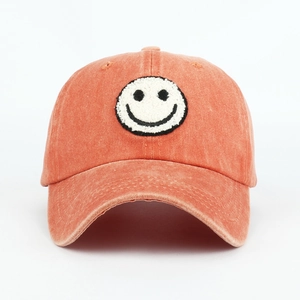 Vintage orange washed cotton baseball cap with fuzzy towel embroidered smiley patch