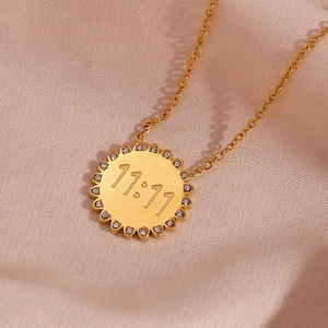 Macro shot of 18K gold plated 11:11 sunburst pendant necklace with crystal accents