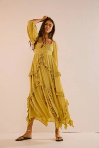 Close-up of mustard yellow maxi dress featuring tiered ruffles and fine fabric texture