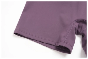 Detailed close-up of dark purple yoga shorts featuring professional flatlock stitching