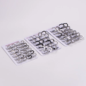Polished pentagon stainless steel hoop earrings displayed on branded cards
