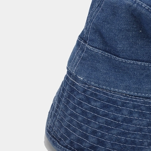 Close-up of the meticulous stitching on the brim of this dark blue denim bucket hat