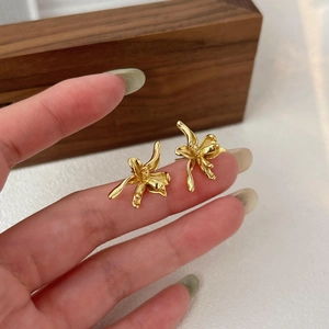 925 silver golden orchid flower stud earrings held in hand with wooden jewelry box