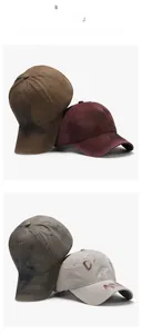 Detail showing distressed cotton texture and red graffiti spray paint on a baseball cap
