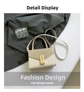 Detail of cream crossbody bag featuring glitter flap and golden bar metal clasp