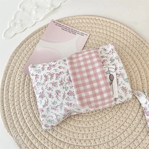 Floral nurse pocket protector with pink plaid flap and convenient hanging strap detail
