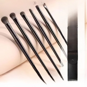 Detailed view of a 6-piece eye makeup brush set with a black portable storage bag