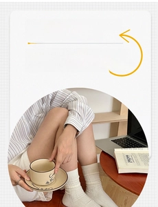 Detailed texture of cream-colored mid-tube cotton socks with vertical stripes and patterns