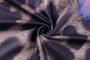 Close-up of flexible knit leopard print fabric in purple and brown for women dress