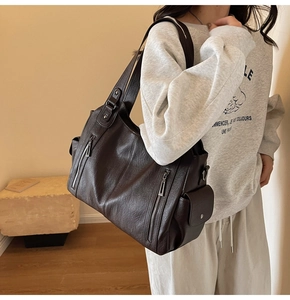 Detailed view of coffee brown tote bag with metal zippers and multi-pocket design