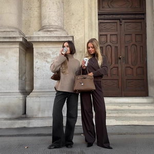 Chic high-neck knit sweater and leather handbag in a European street style fashion setting