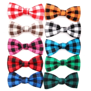 Collection of plaid buffalo check pet bowties in various colors on white background