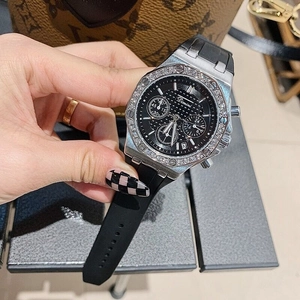 Detailed close-up of multi-function chronograph watch dial with silver diamond-set bezel