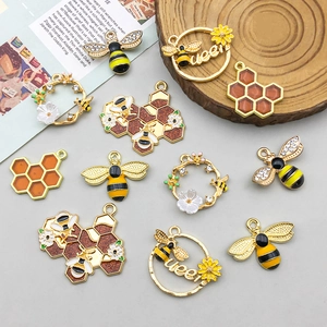 Detailed flat lay of 11 assorted yellow enamel bee and honeycomb DIY jewelry charms