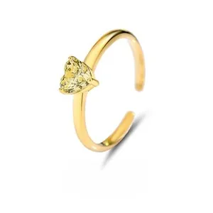 Macro detail of S925 silver heart ring featuring a yellow gemstone in golden finish