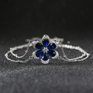 Elegant double-layered silver bracelet with a sparkling blue zircon flower charm
