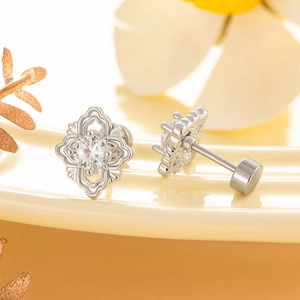 Vintage silver flower stud earrings with zircon crystals and screw back on floral background