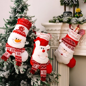 Three knitted Christmas stockings with 3D Santa Reindeer Snowman on festive fireplace
