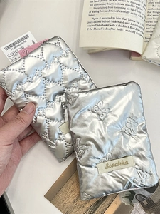 Set of two silver quilted bow travel organizer bags for passports and accessories