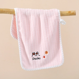 Hanging pink coral fleece hand towel with cute duck embroidery on a wooden branch