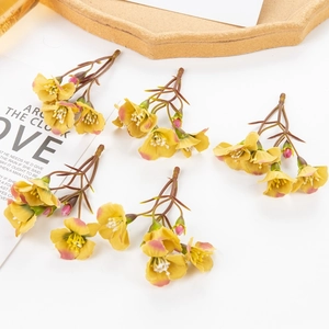 Detail of yellow and pink artificial flower clusters for DIY handmade accessories