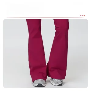 Detail view of the flared pant leg design on thermal fleece yoga jumpsuit in magenta