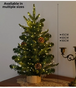 Mini Christmas tree detail with pine cones, LED lights and natural wooden base