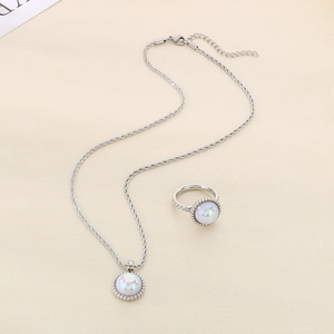 Detail of silver twist chain necklace and ring set with round white cat's eye stone