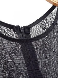 Close-up of the elegant neckline zipper on the floral lace dress with sheer mesh texture