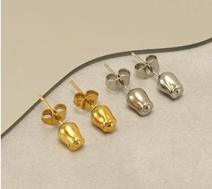 Detailed view of tulip-shaped stud earrings in gold and silver stainless steel finishes