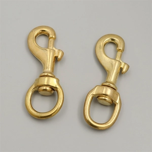 Close-up of dual solid brass lobster clasps for DIY bags and pet leashes with gold finish