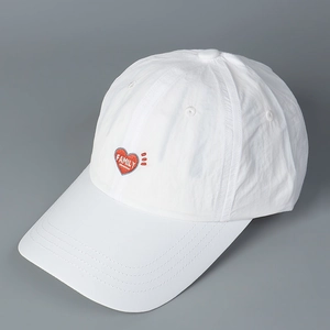 Detail of white quick-dry baseball cap with red heart FAMILY embroidery and breathable eyelets