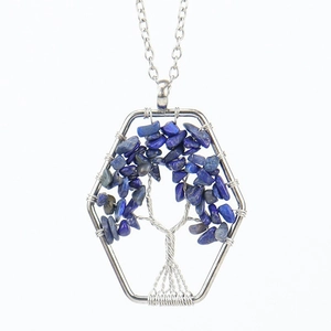 Detail of tree of life pendant with blue lapis lazuli stones in silver hexagonal frame
