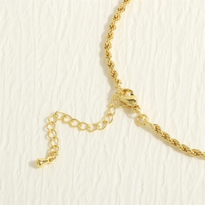 Detaillierte Makroansicht der goldenen Torsionskette mit Karabinerverschluss und Verlängerung