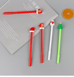 Close-up of Christmas gel pens with festive silicone toppers on a decorative background