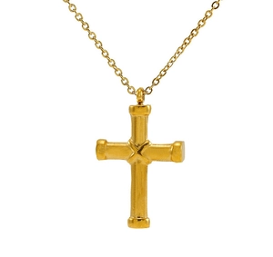 Macro detail of gold cross pendant with brushed vintage texture on thin metal chain