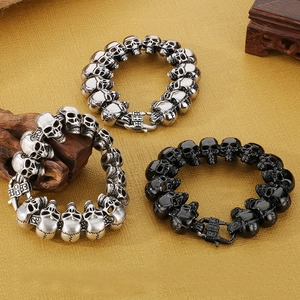 Vintage gothic skull bracelets in silver and black steel shown from a top-down view